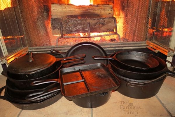 various cast iron cookware pieces in front of fireplace
