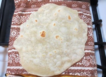 homemade flour tortillas cooling on bag