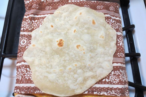 homemade flour tortillas cooling on bag