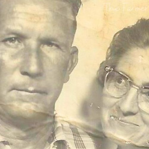 papa and granny he's wearing a stripped shirt and she is smiling up at him