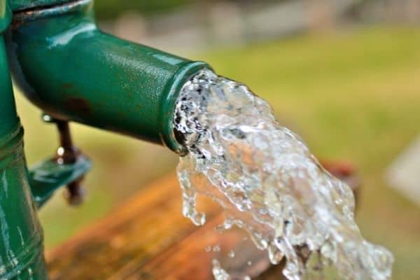 water gushing from water well pipe for a whole house filtration system for well water