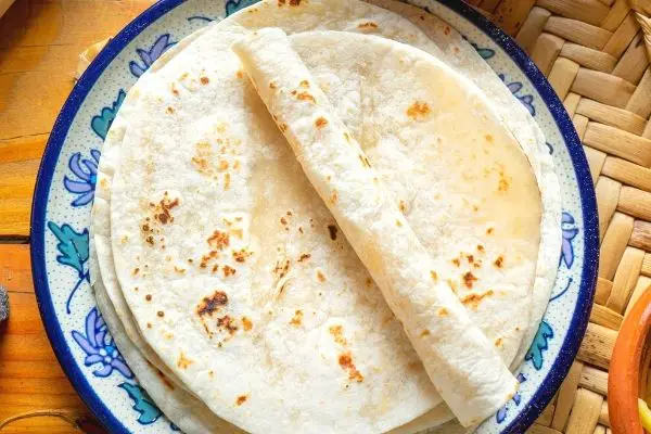 einkorn tortillas on a blue plate