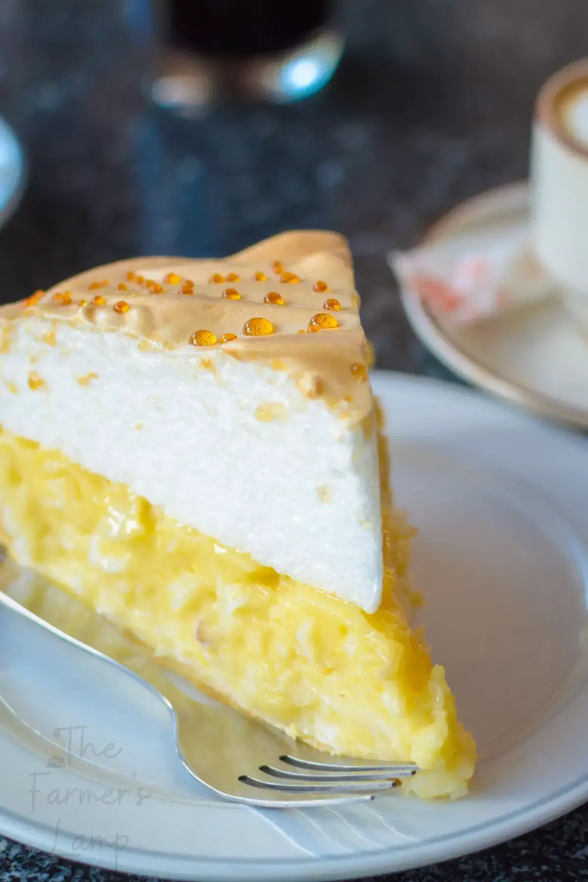 slice of coconut cream pie on a white plate