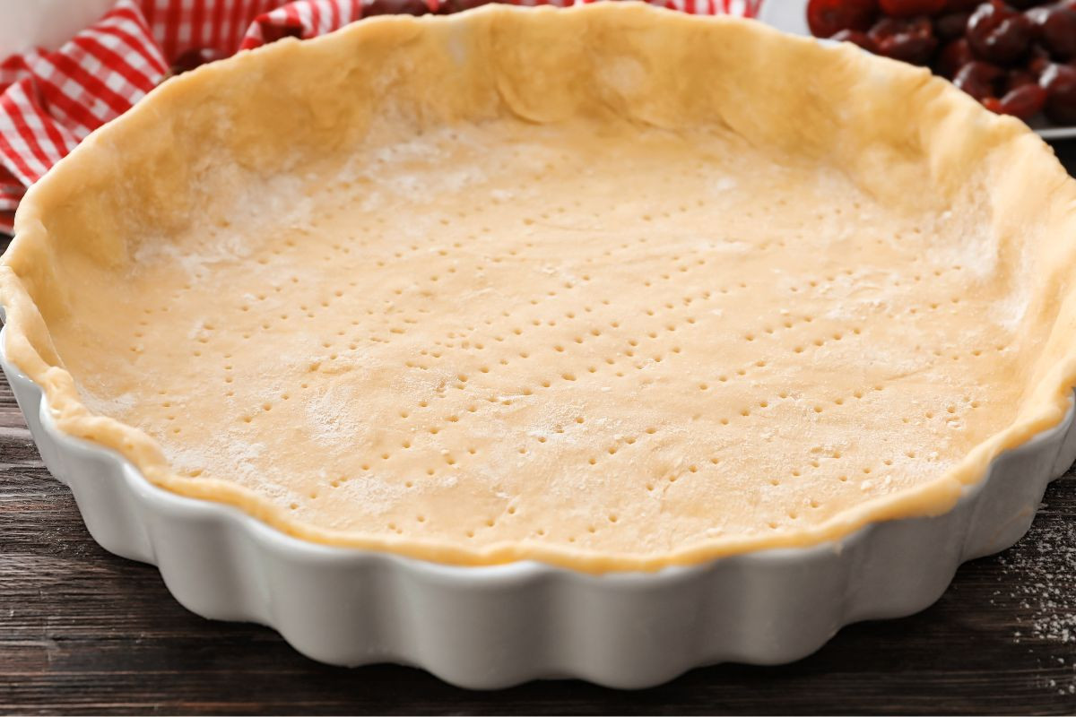 homemamde pie crust in a white pie plate