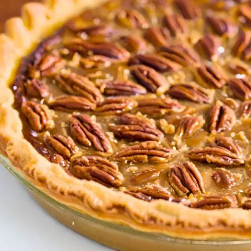 old fashioned southern pecan pie in a clear glass pie plate