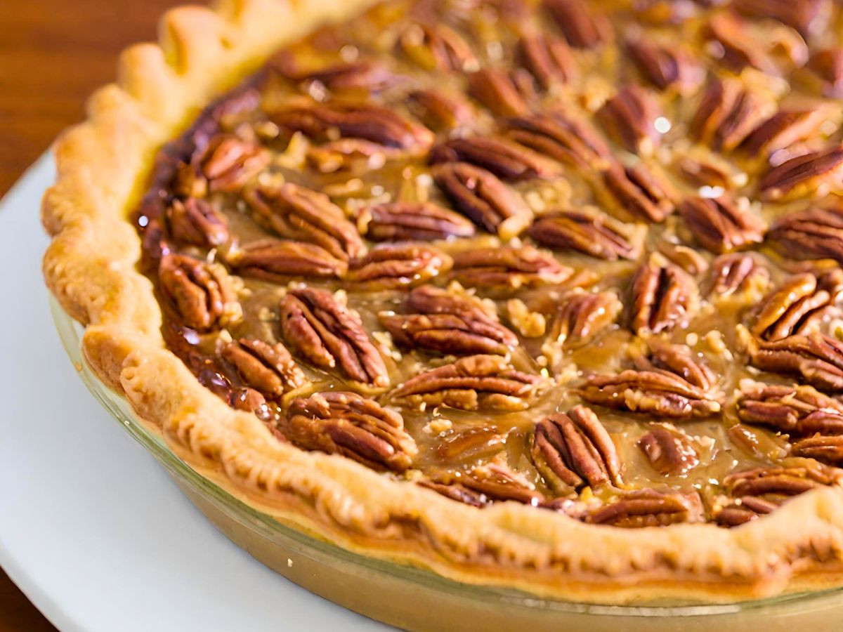 old fashioned southern pecan pie in a clear glass pie plate