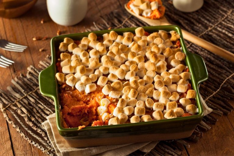 sweet potato casserole with marshmallows on top in a green casserole dish