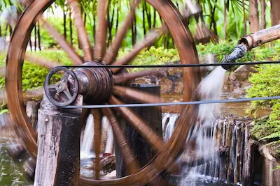 paddle wheel with a belt attachec to it being driven by a micro turbine motor to provide hydropower on the homestead