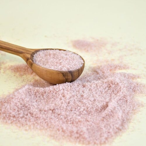 redmonds real salt on a wooden spoon with some spilled around it