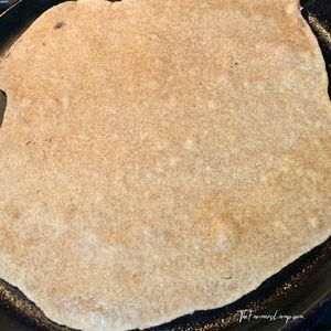 Spelt Flour Tortillas 7 spelt flour tortilla cooking on a cast iron griddle bubbles indicating its ready to flip
