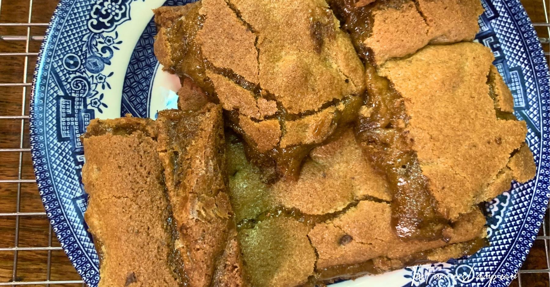 chocolate chip spelt cookies sliced sitting on a blue willow plate