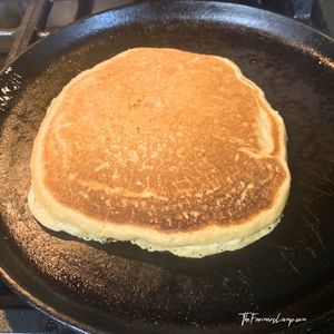 Spelt Flour Pancakes Small 4 golden brown splet flour pancakes on a cast iron griddle