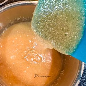 Sugar mixture melting in saucepan on stovetop