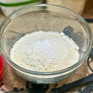 Dry coconut and almond flour mixture in glass bowl